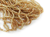 Glass beads, 2x3mm faceted rondelle, light khaki with half coat Topaz color (#89) | 玻璃珠, 2x3mm, 切面扁珠, 半透淺米黃 X 半邊鍍琥珀金色 (#89)